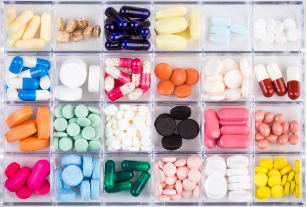 Various medicine pills and capsules in plastic container
